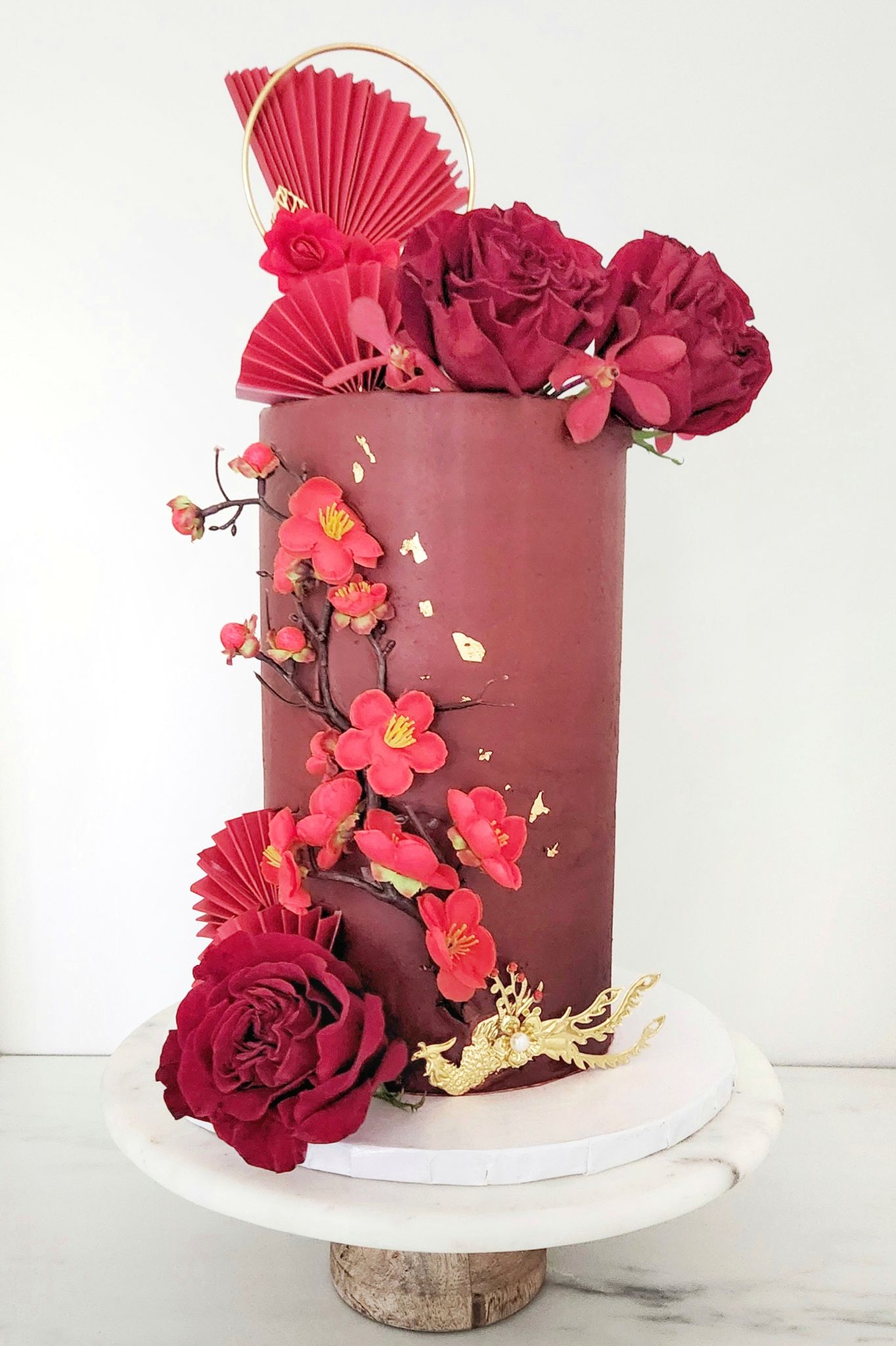 Double barreled tall red and gold wedding cake · Double barreled tall red and gold wedding cake