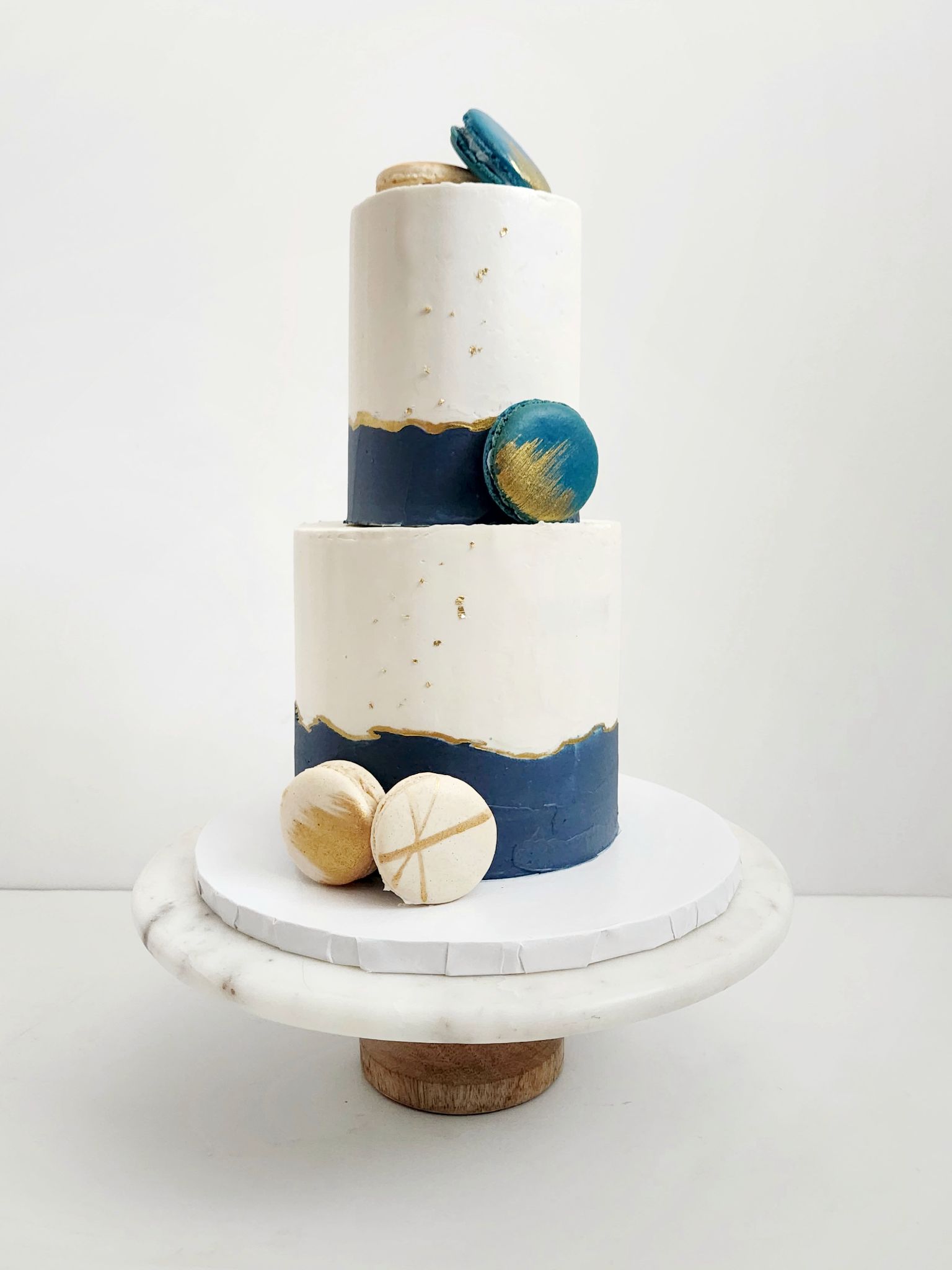 White, navy, gold macaron cake · White, navy, gold macaron cake
